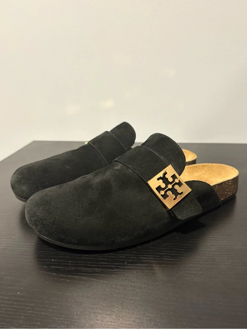 Tory Burch black suede slip-on mules in a size 7.5